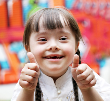 Portrait of beautiful happy girl giving thumbs up.