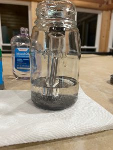 magnet in jar with oil and filings
